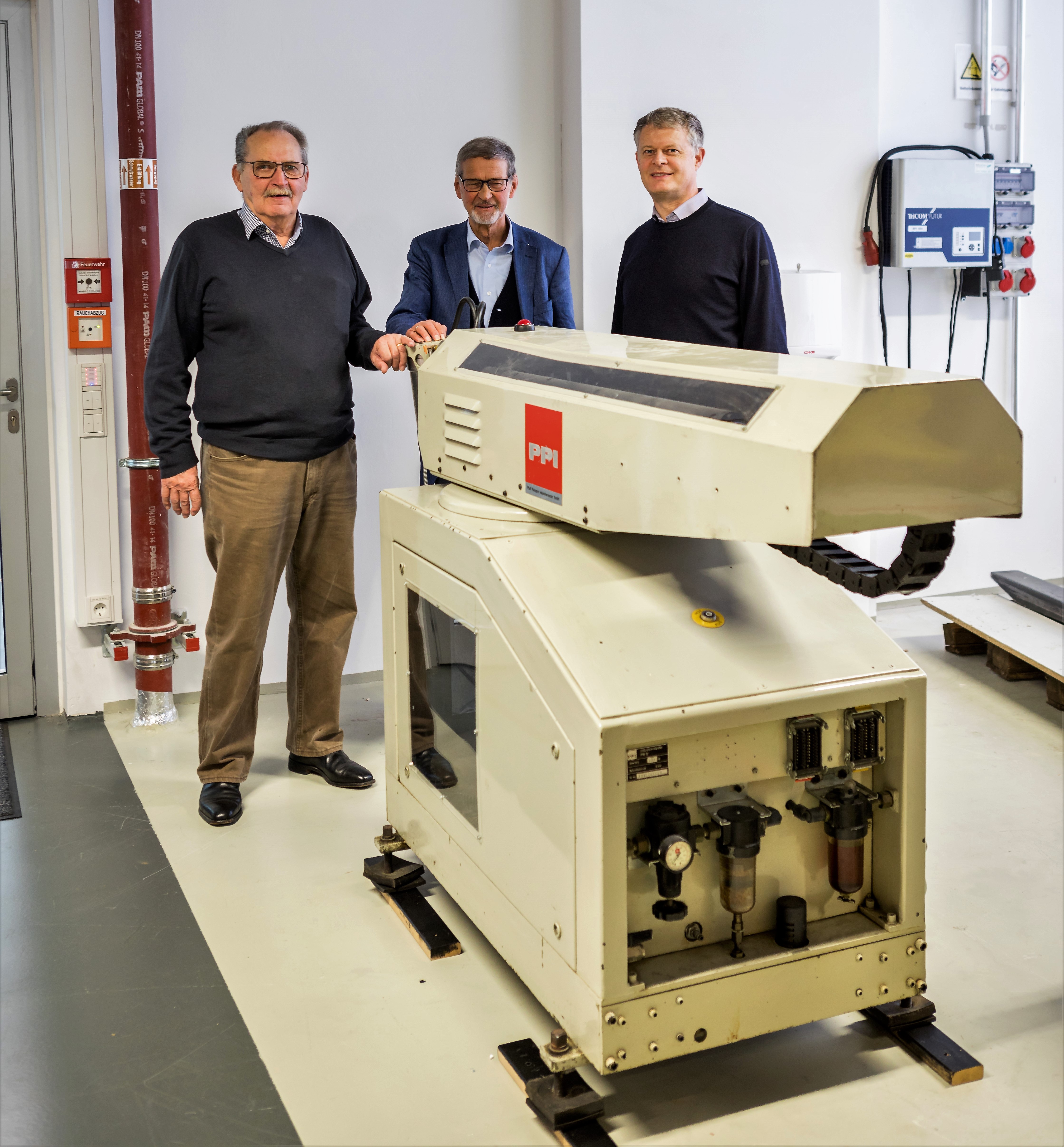 Rolf Dieter Schraft, Alfred Neugebauer und Martin Hägele mit dem Handhabungsroboter PPI PM 12