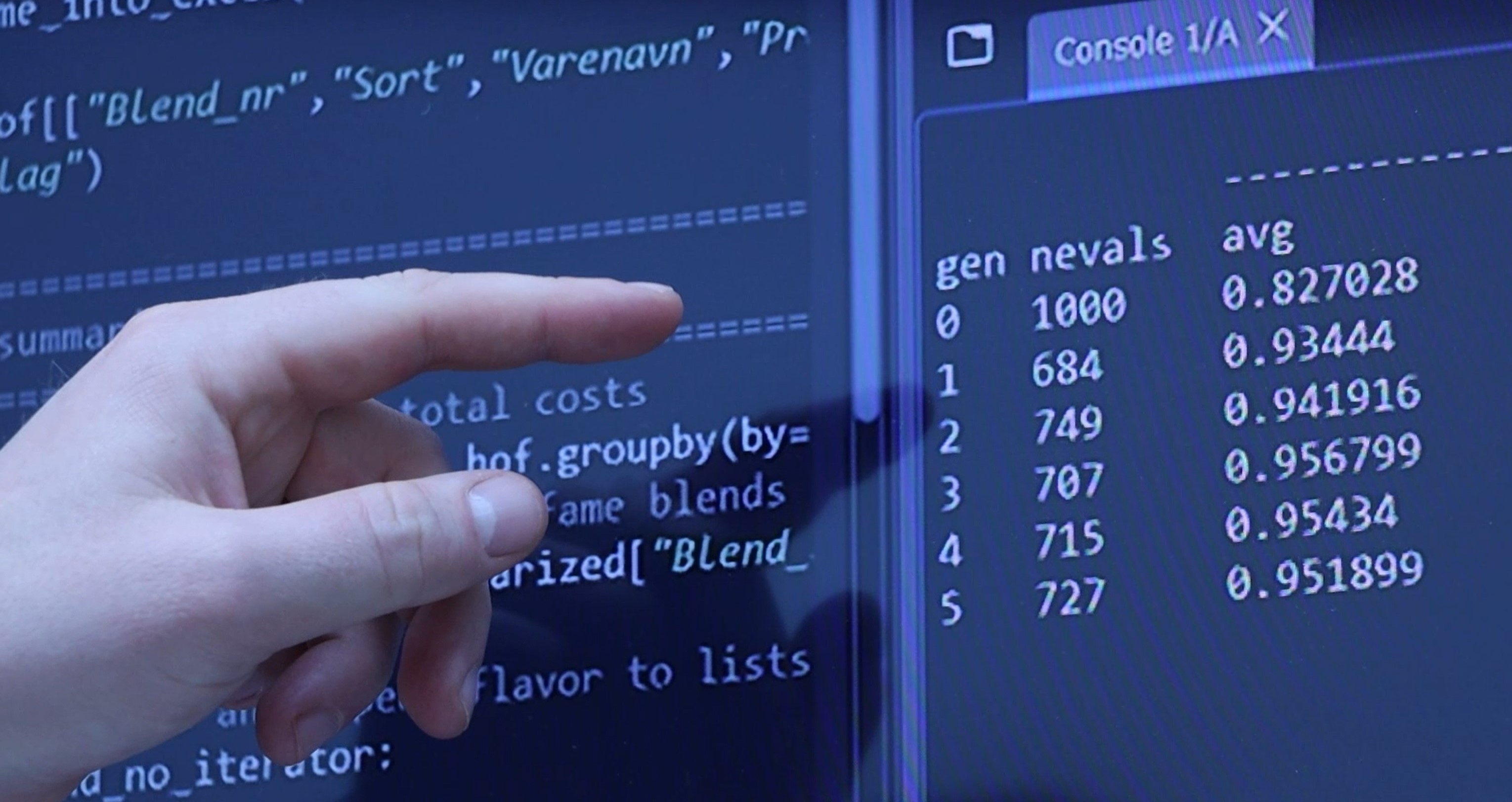 Index finger of a left hand points to lines of code on a screen