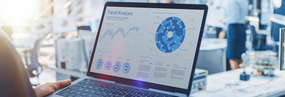 Stylish Female Industrial Robotics Engineer Uses Laptop Computer with Graphs and Diagrams in Trend Analytics Software. Technology Research Facility for Machine Learning and Cloud Computing