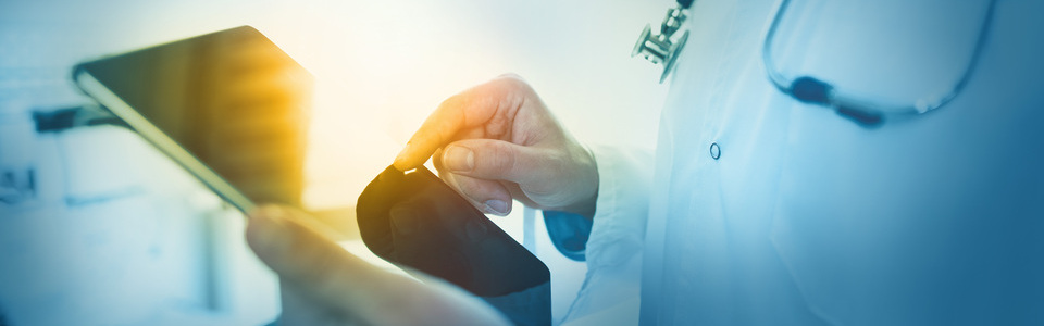 Doctor using tablet in clinic