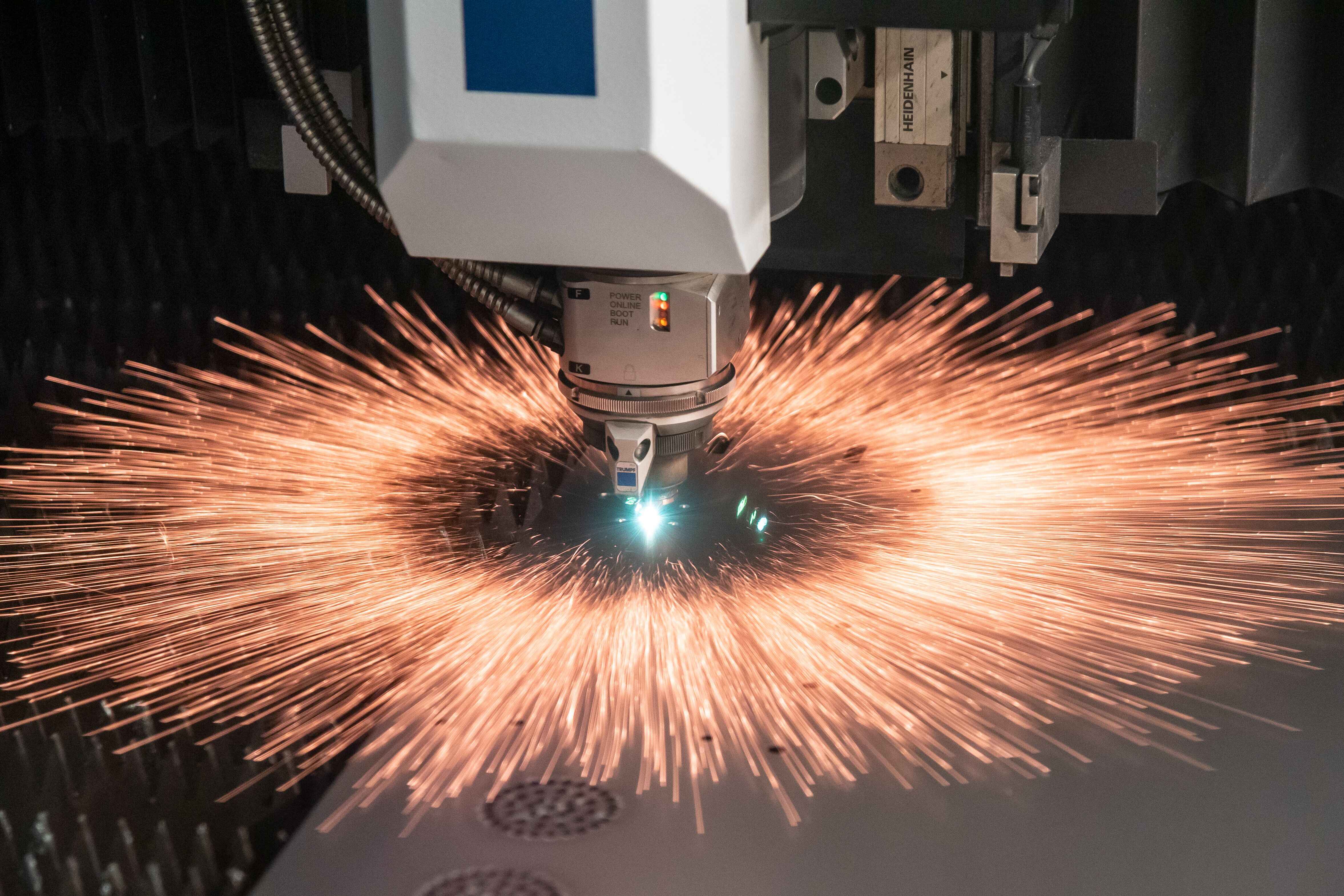 A laser machine cuts a component